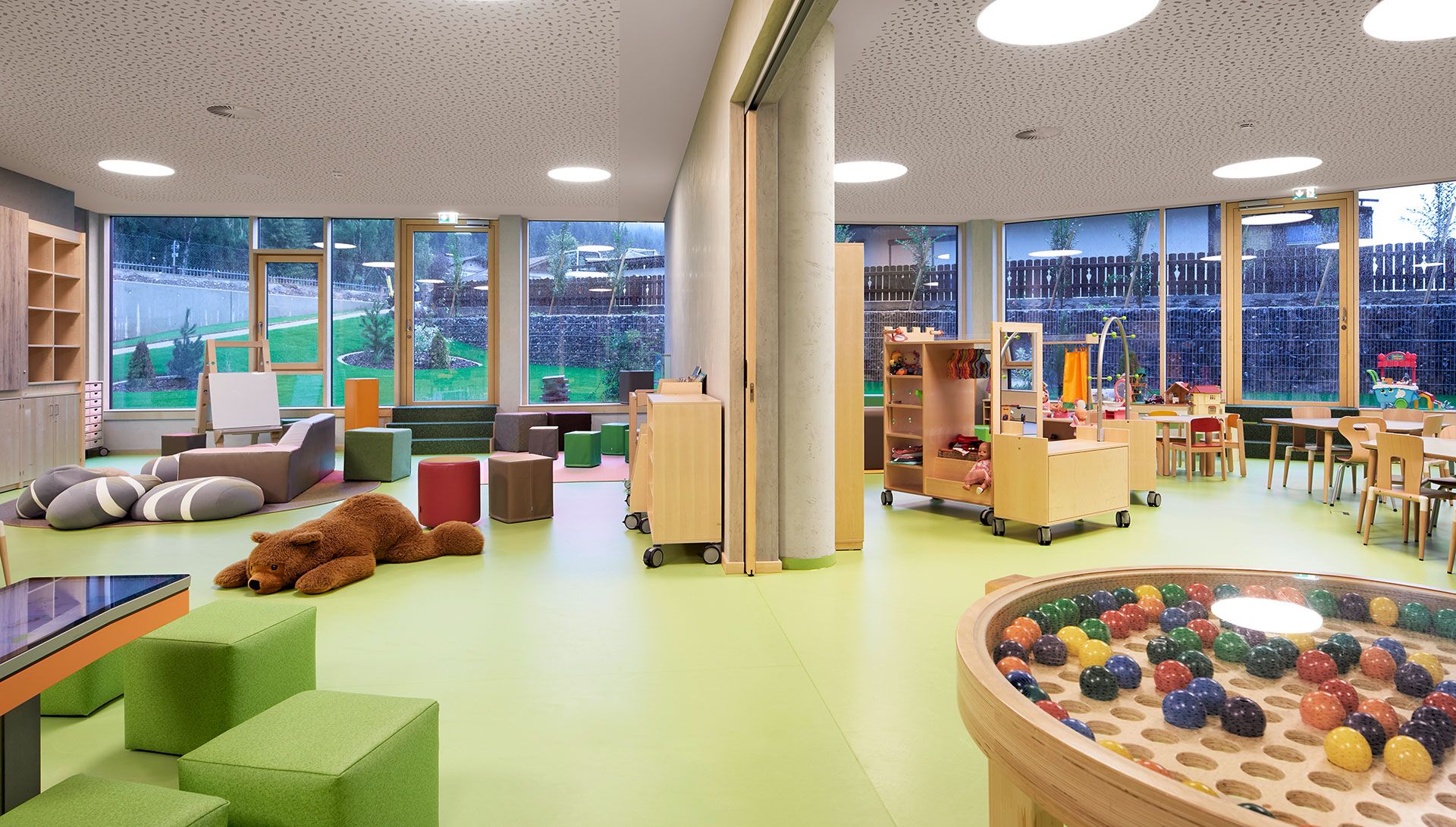 Sunlit room as a paradise for children with numerous toys and seating options. Sunlit room as a paradise for children with numerous toys and seating options.